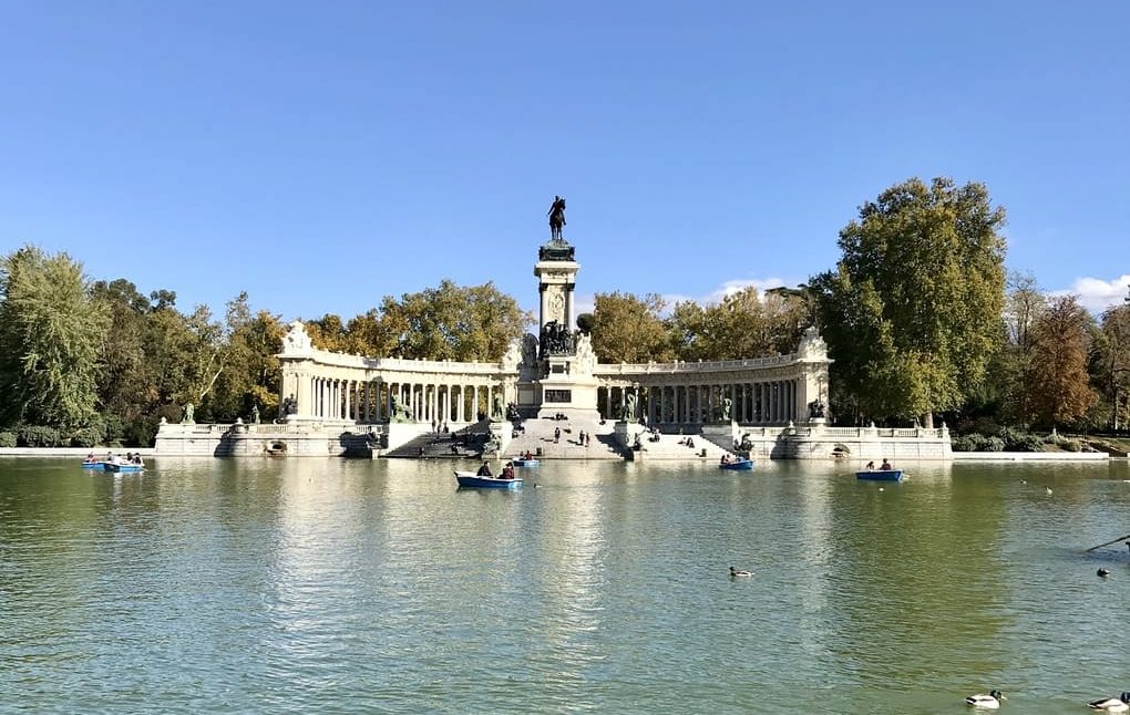 Familias disfrutando del Parque del Retiro en Madrid con niños jugando y paseando